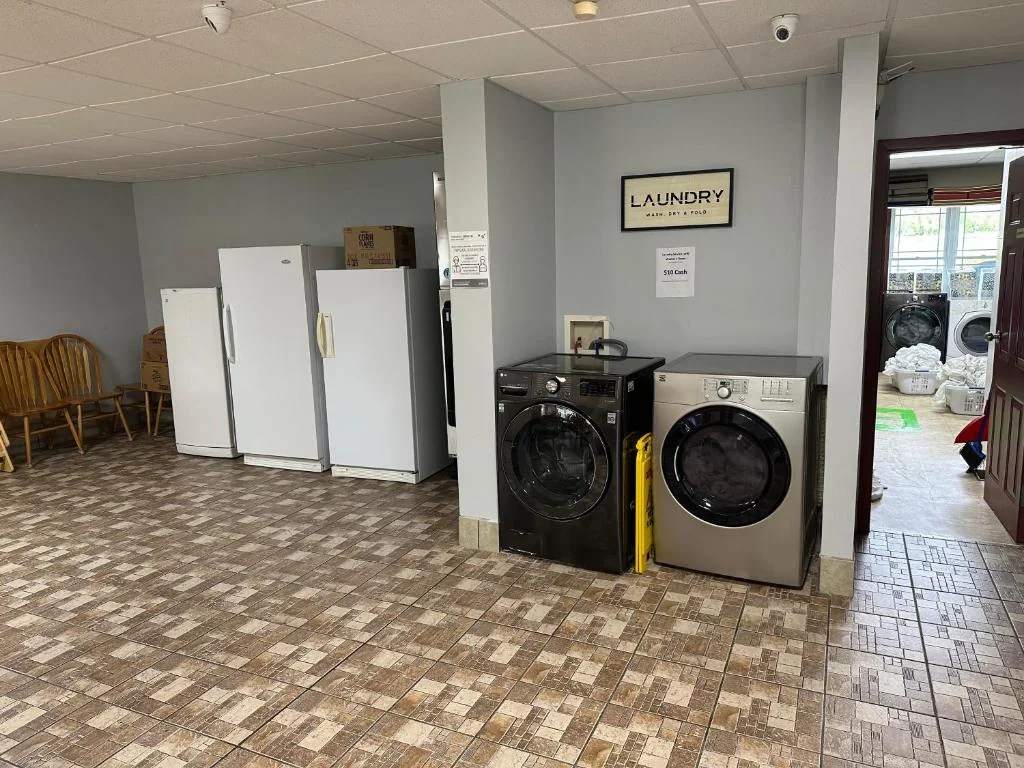 Self-service laundry room with washers, dryers and fridges